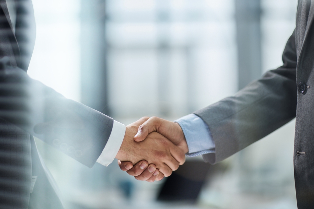 Professional handshake — committed partnership in commercial recovery